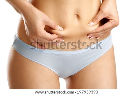 Closeup girl in unederwear pich her belly  on white