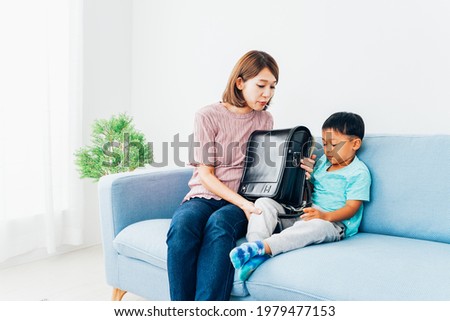 Little boy playing with his mother at home
