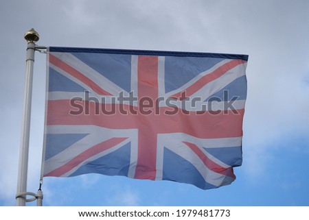 the flag of the state of Britain on a flagpole against the sky