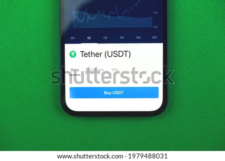 Buy Tether USDT cryptocurrency, mobile app with button, concept of online trade and exchange by using smartphone, banking application, top view photo of business office desk