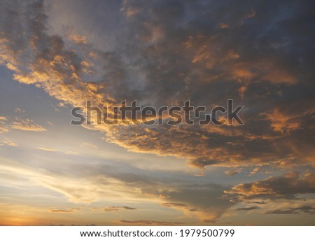Gold color cloud and blue sky in magic hour at sunset, The horizon began to turn orange with purple clouds at night, Dramatic cloudscape area	 Royalty-Free Stock Photo #1979500799