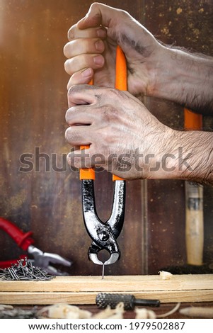 A man's hand using tools