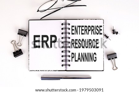 Notebook with ERP on the table with office tools