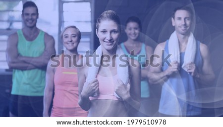 Composition of smiling men and women in fitness class with spot lights. sport, fitness and active lifestyle concept digitally generated image.