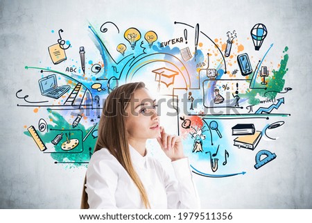 Attractive woman in white shirt pondering about education and future perspectives. Colourful symbols of educational and learning process on concrete wall. Concept of business university