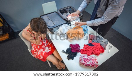 Delayed beautiful girl at the airport suspected of drug smuggling Royalty-Free Stock Photo #1979517302