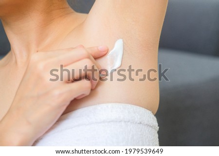 Woman applying cream and lotion on armpit, treatment and cosmetic and cleaning. Royalty-Free Stock Photo #1979539649