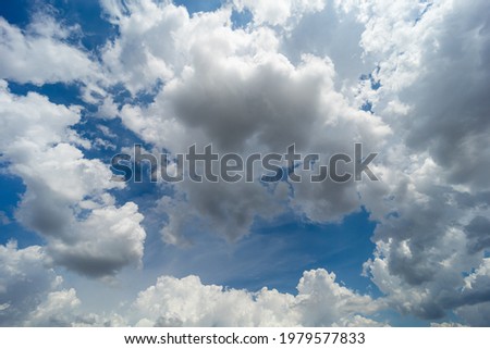 Cumulus white clouds floating on blue sky.