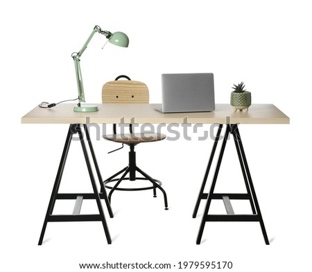 Stylish workplace with wooden desk and comfortable chair on white background Royalty-Free Stock Photo #1979595170