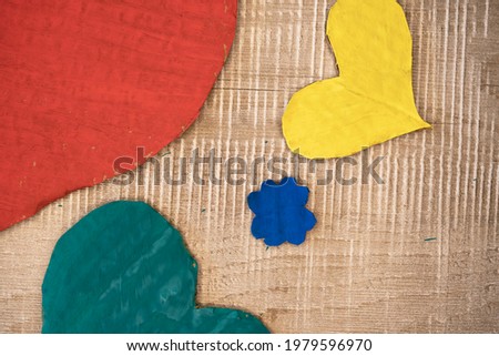 handmade cardboard heart and flower motif green red yellow