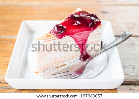 Delicious whipped cream crepe cake with blueberry sauce, stock photo