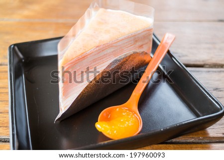 Light cream crepe cake with fresh orange, stock photo