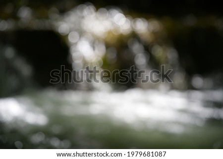 Blurred little stream in the forest with waterfall at springtime. Photo taken May 25th, 2021, Zurich, Switzerland.