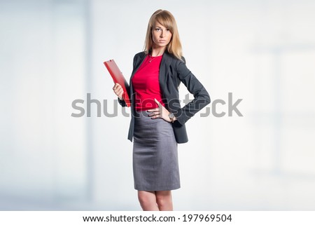Portrait of young business woman with red folder gray skirt shirt classical costume in office, isolated on white background