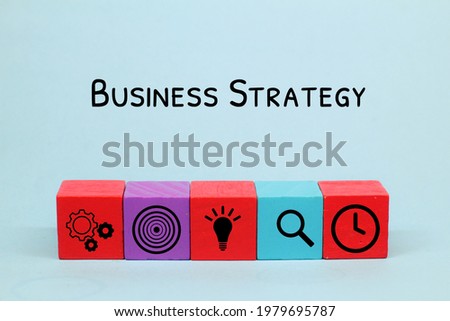 Concept of business strategy and action plan. Wood cube block stacking with icon.