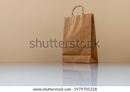 brown paper bag on white glass table. Space for text