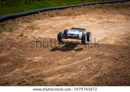 White Radio Controlled (RC) Offroad Truggy on an outdoor track training during sunny day Royalty-Free Stock Photo #1979745872