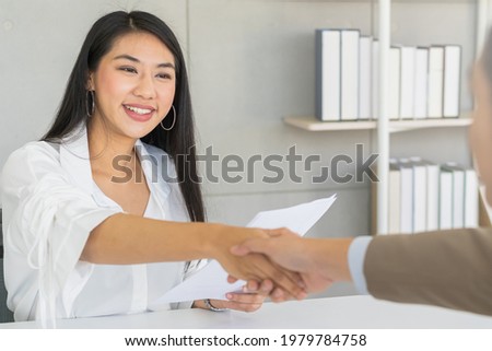 Successful asian young woman, man partnership, teamwork handshake or greeting together at office after project done, good deal. Happy business people, worker or group meeting, shaking hands concept.