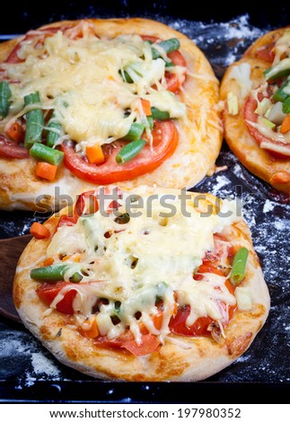Mini focaccia with tomatoes, cheese and herbs. Shallow dof.