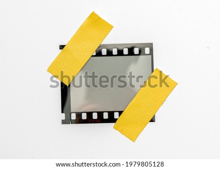 blank or empty 35mm dia film frame fixed by two yellow adhesive strips on white background, cool photo placeholder. 