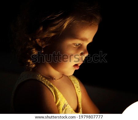 Photo of a child near a flashlight
