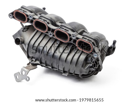 Intake manifold plastic housing with a system for adjusting the air flow to the engine. Repair and replacement of spare parts of vehicles in a car service. Royalty-Free Stock Photo #1979815655
