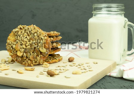Cookies and milk as a background with space for text. Delicious homemade cookies and milk with honey on rustic wood background