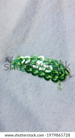 Green sequin detail in cotton cloth