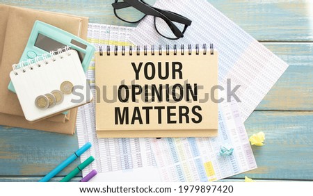 Business concept. Notebook with text Your Opinion Matter sheet of white paper for notes, calculator, glasses, pencil, pen, in the white background