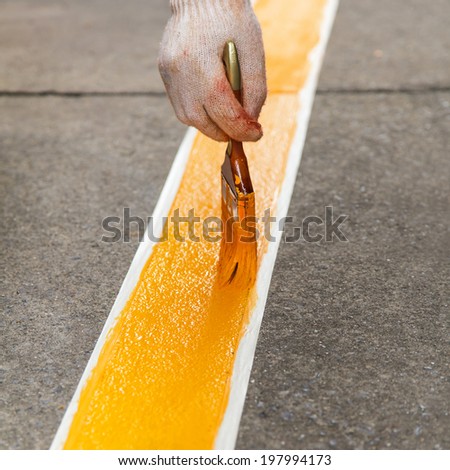 Painting yellow line on the floor
