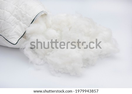 Hygiene white pillow display cotton wool inside. Pillow wool.  Royalty-Free Stock Photo #1979943857