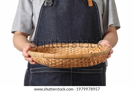 Chef holding wooden basket isolated on white background