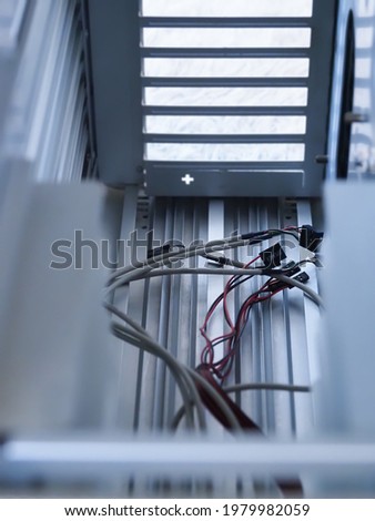 Inside an emptied or abandoned PC case with detached connectors inside. Shallow depth of field.