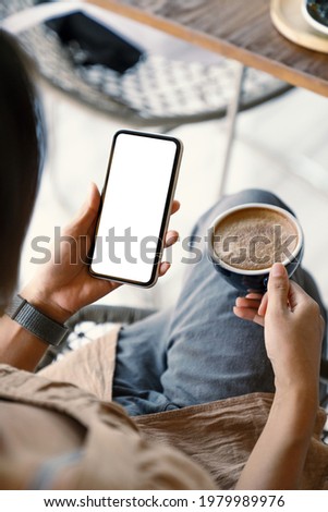 woman holding smart phone showing white screen at morning