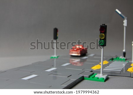 Road safety concept - toy crossroad with traffic signs and a red pickup