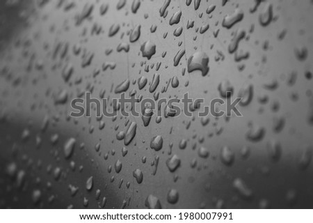 Beautiful raindrops on glass with texture dark gray background 