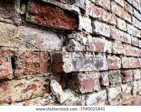 Old crumbling brick wall as an abstract background.