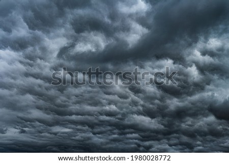 Dramatic sky with storm clouds before rain. Panoramic view of the stormy sky and dark clouds.  Concept on the theme of weather, natural disasters.