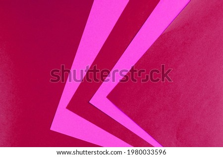 Abstract pink and red geometric background. Two-color Repeating angles and lines. Top View, Flat Lay. Copy space.