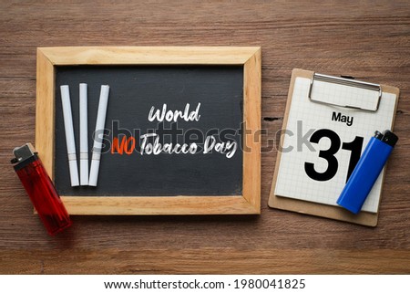 World no tobacco day lettering over chalkboard background. Stop smoking concept