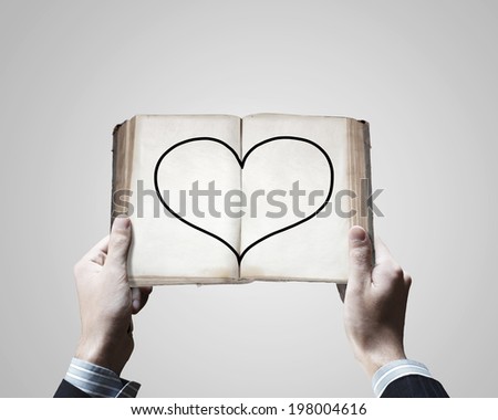 Close up of male hands holding opened book