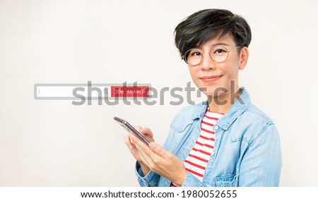 A young beautiful and stylish asian woman using her smartphone search for a new job as COVID-19 crisis is profoundly affected employment. Search tools, Unemployment, Hope, Financial crisis, Career. Royalty-Free Stock Photo #1980052655