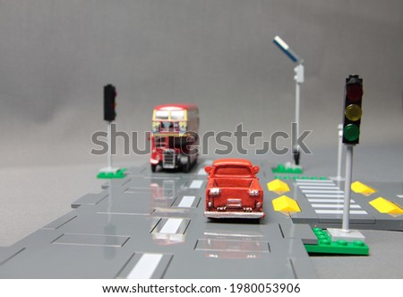 Road safety concept - crossroad model with traffic signs, pickup and a bus