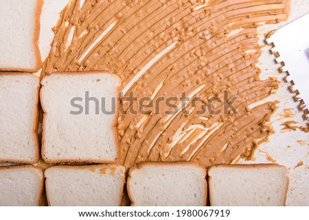 Architect bread with peanut butter character and toasts. Toast - tiles
peanut butter - cement. Abstract food concept