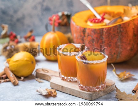 Pumpkin punch or sangria in a big pumpkin. Halloween and Thanksgiving. Traditional autumn, winter drinks and cocktails