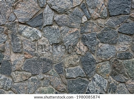 Granite stone block wall texture.