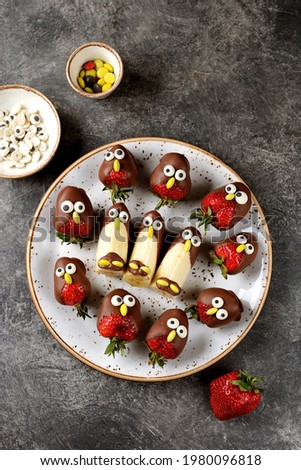 Strawberries and bananas in chocolate in the form of birds. Cute idea for kids party. 