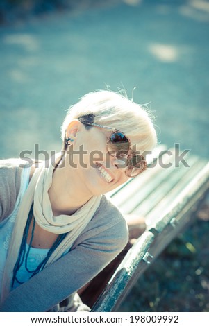 beautiful young blonde short hair hipster woman in the city