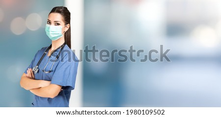 Young masked female nurse portrait, covid coronavirus mask. Wide background with large copy-space