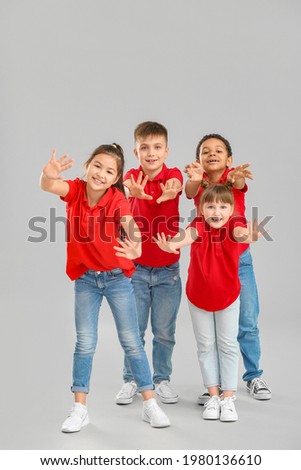 Cute little dancers on grey background